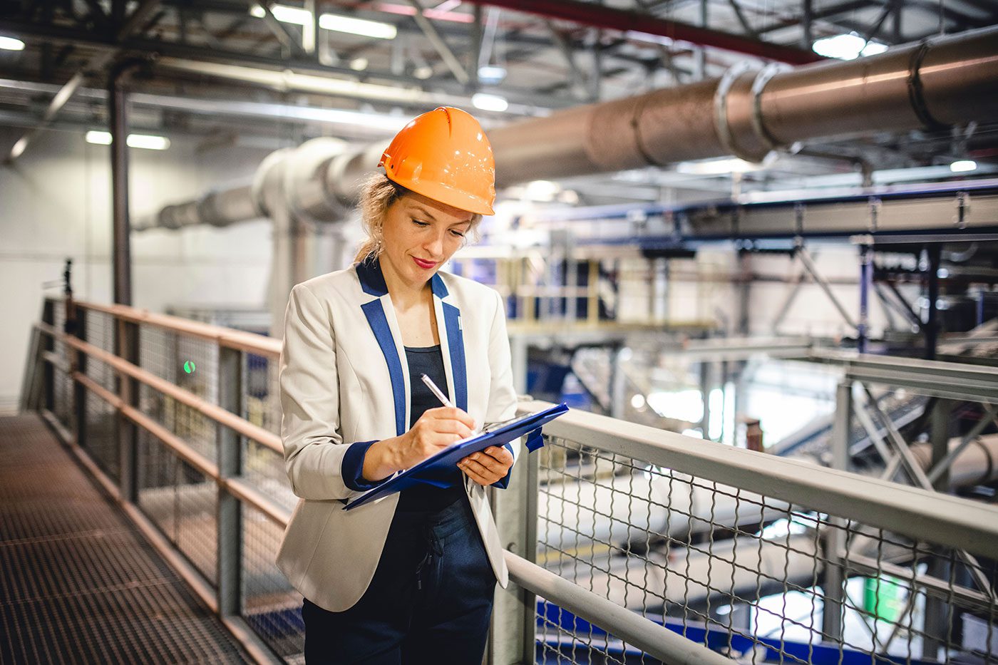 A woman in factory taking notes