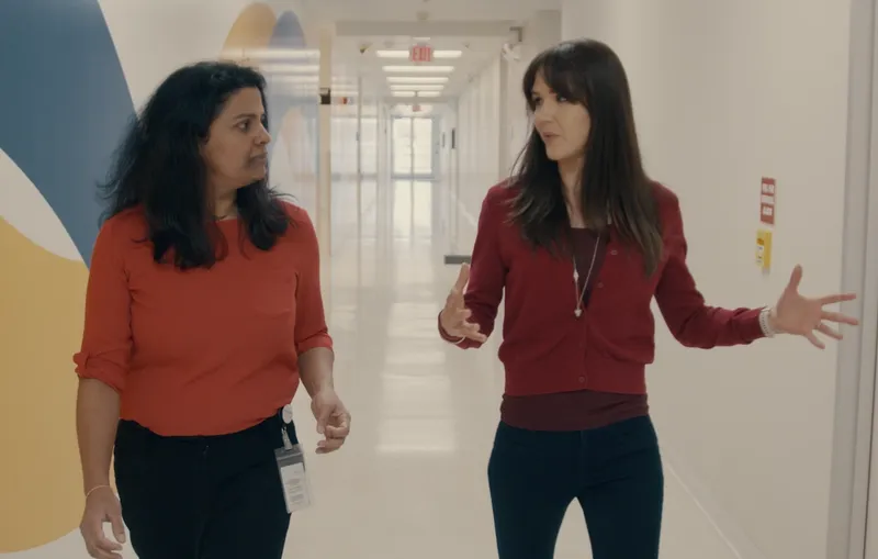 Kate converses with a coworker. 