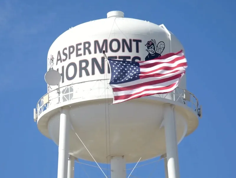 water tower with American flag hanging from it