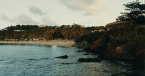 water and cliffs with a beach in the distance