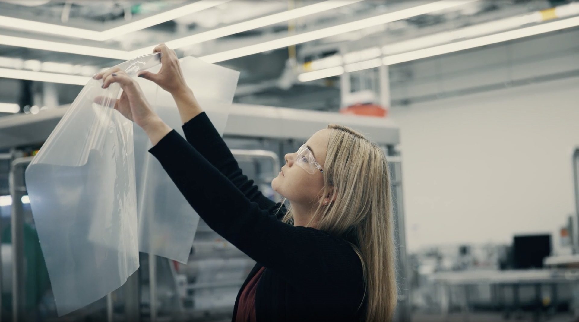 Jessica holding up a piece of plastic film