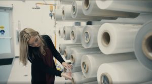 Jessica inspects stacks of plastic wrap