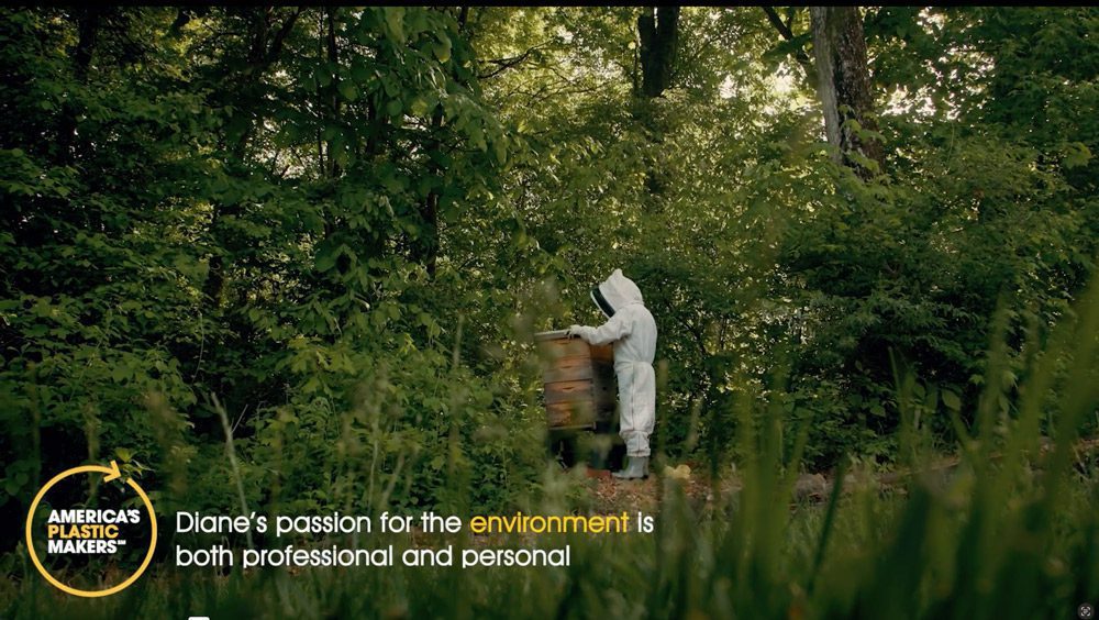 Person in beekeeper suit. 