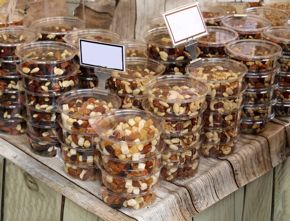 Nuts dried fruits in plastic containers.