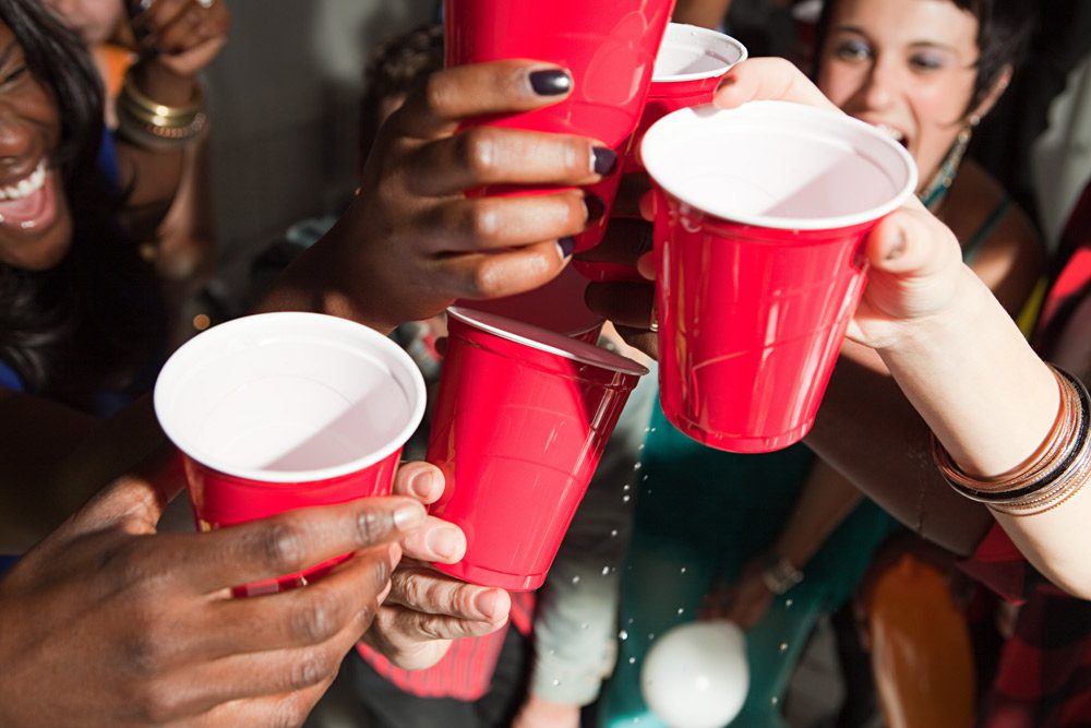 People with plastic cups at party