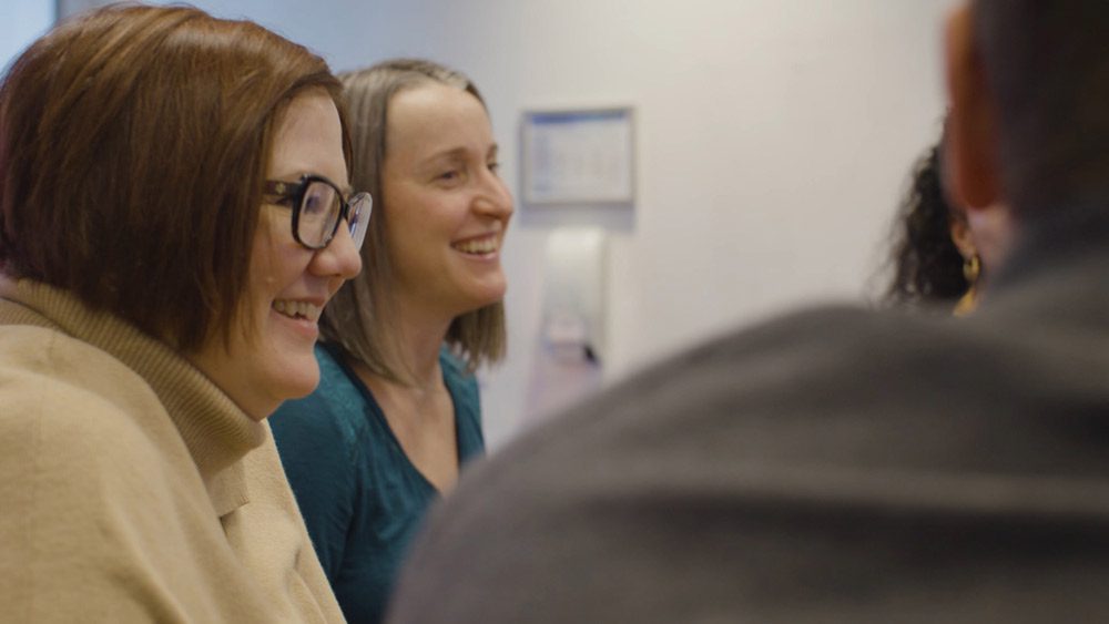 Julianne with coworker laughing