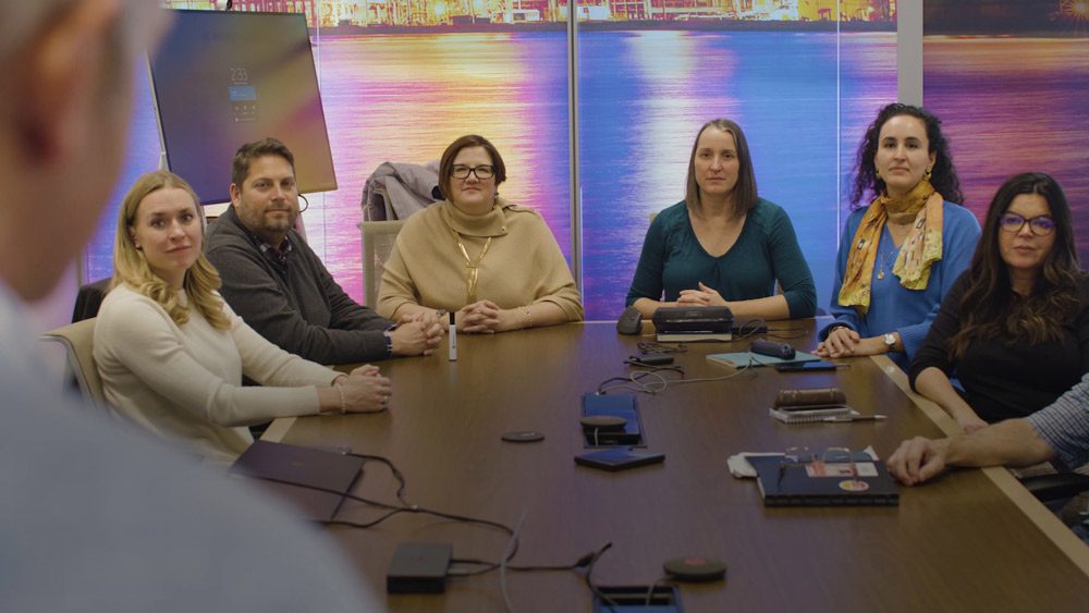 Coworkers sitting around conference table..