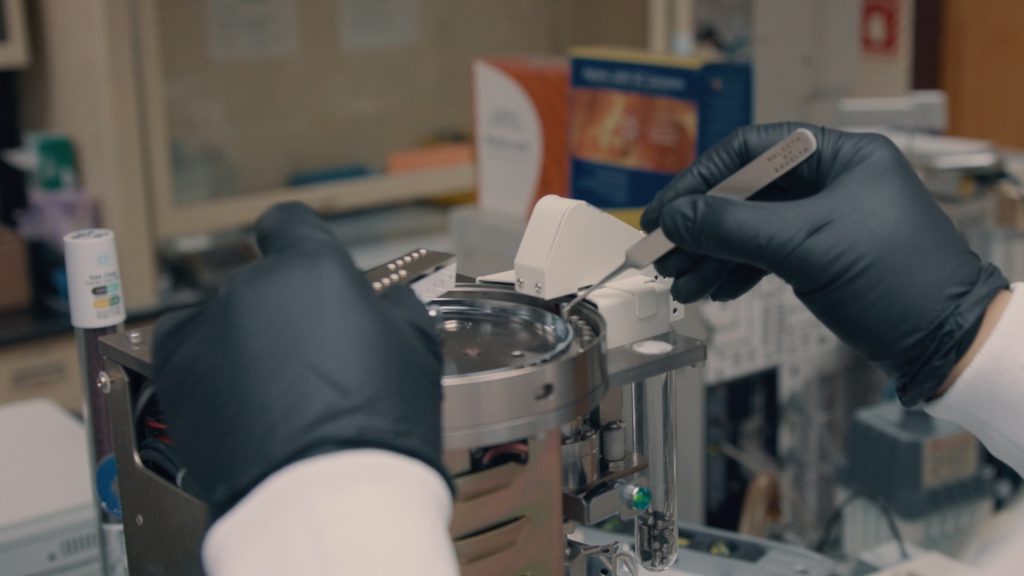 A scientist using a scientific instrument
