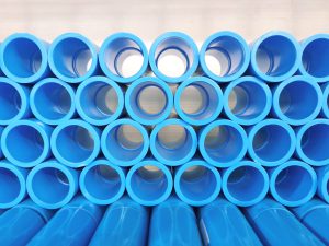Stacked blue pvc pipes.