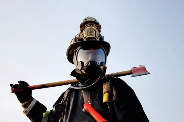 Firefighter holding axe.