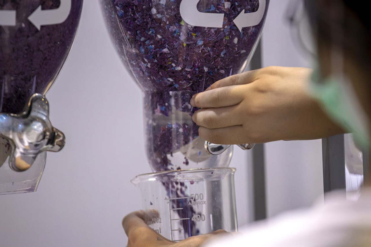 Women Holding Plastic Flakes in Recycled Plastics