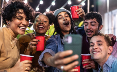 Friends at party holding red plastic cups.