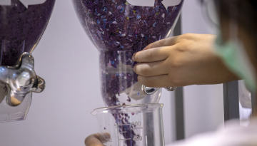 Women Holding Plastic Flakes in Recycled Plastics