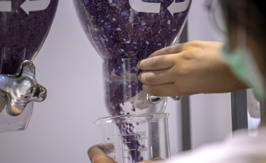 Women Holding Plastic Flakes in Recycled Plastics
