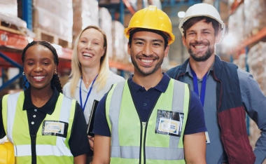 A smiling team of warehouse workers